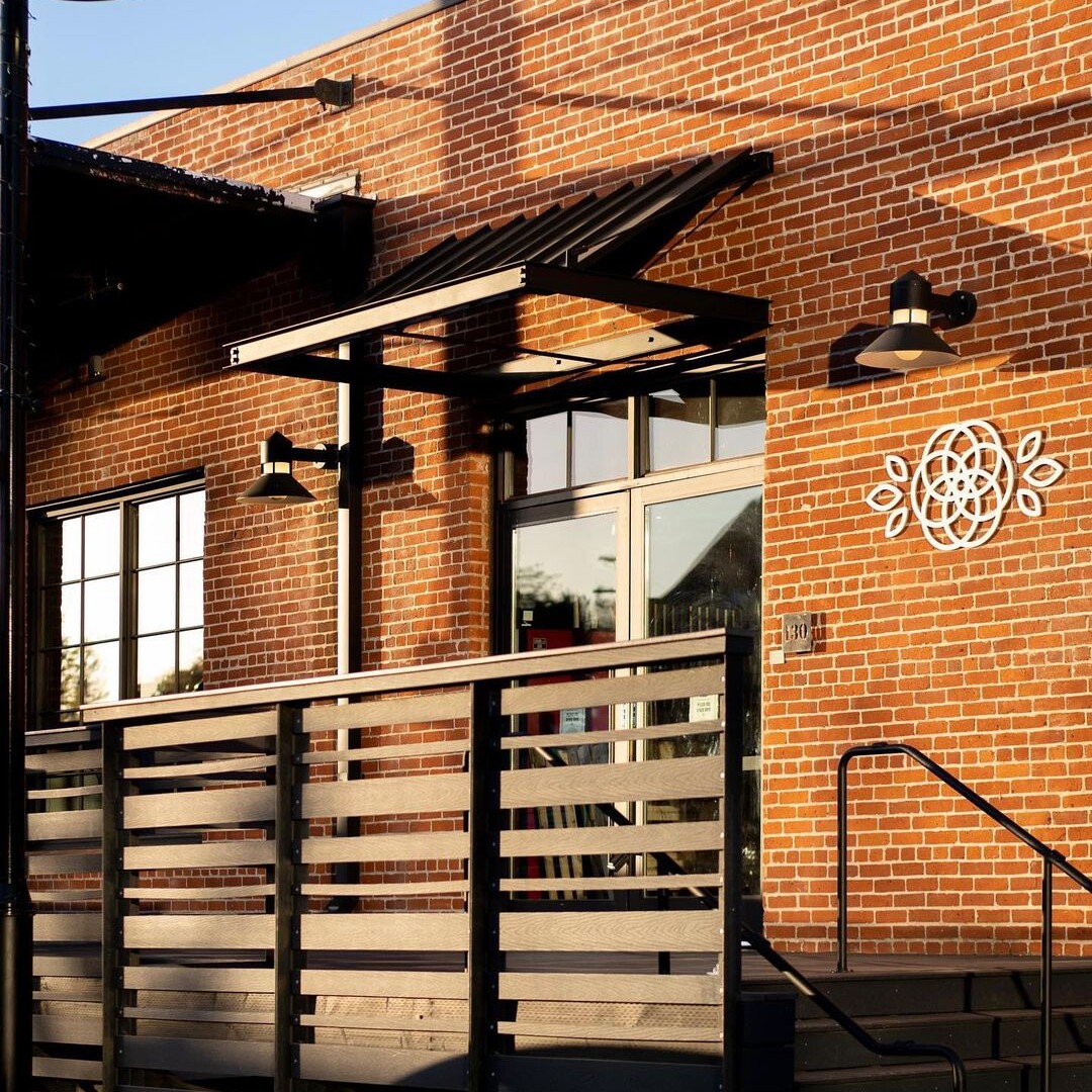 The front of a brick building with a sign for a Sacramento Coffee Shop.